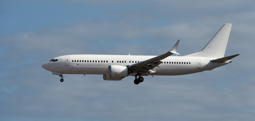 The plane lands.Airplane, passengers flying in the blue sky, preparing to land at the airport	