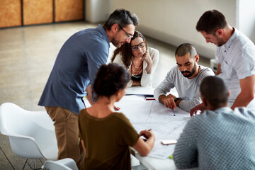 Group, planning and business people in meeting, documents and conversation in office. Employees or...