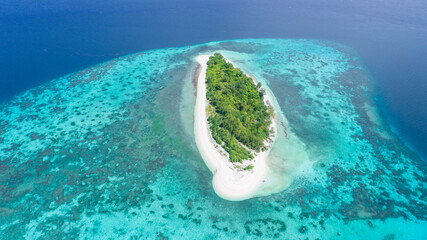top view of tropical island in turquoise blue water. maldives panoramic landscape