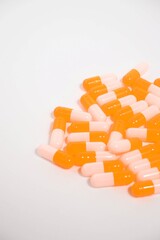 a collection of orange capsules on a white background