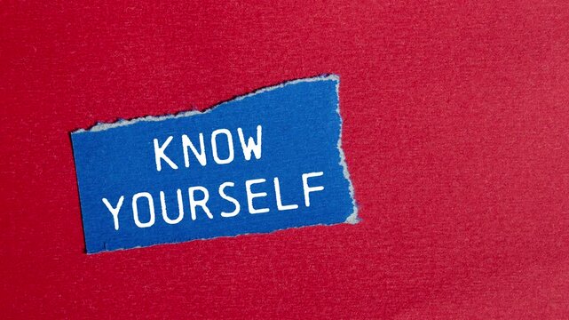 Know yourself message writing on ripped torn blue paper piece on red background. Conceptual know yourself symbol.