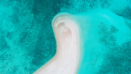 Beautiful white sand beach with clear blue sea and gentle waves, ideal for a peaceful retreat