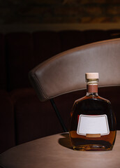 Bottle of cognac resting on a bar table in a nightclub