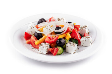 Greek salad with feta cheese, olives, and vegetables on white plate
