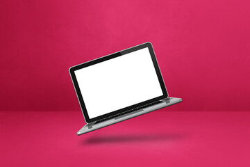 Floating computer laptop isolated on pink. Horizontal background