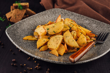 Delicious fried potatoes with dill served on plate