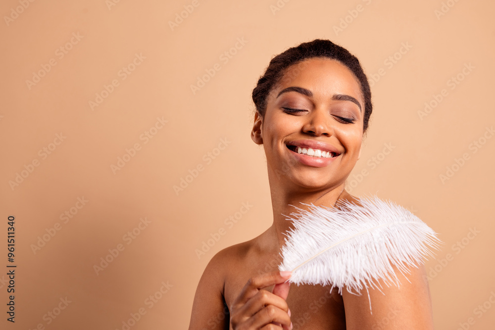 Canvas Prints Photo of gorgeous cheerful woman feather lightness naked shoulders isolated on beige pastel color background