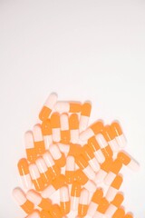 a collection of orange capsules on a white background