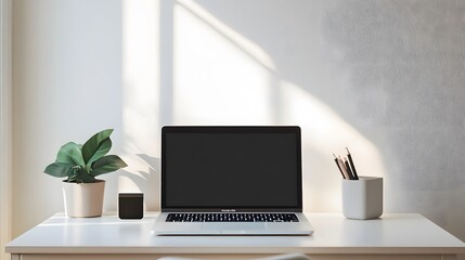 A minimalist workspace with a clean desk, a laptop, and a simple chair