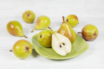 Fresh pears on plate on wooden background. Selective focus