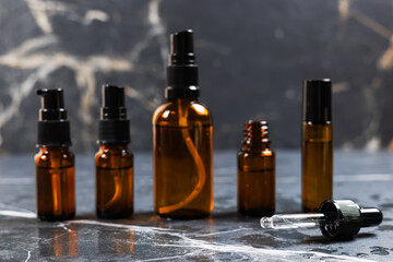Brown amber glass serum oil dropper bottle on table mock-up, cosmetic container in real interior