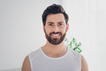 Photo of attractive nice athletic strong bearded man indoors house home gym daylight