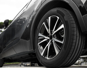detail of modern new black Car. Aluminum wheel with Tire. automobile wheel tire. aluminium rims. Low angle, back, rear view of  vehicle and its tires at the repairing shop. vehicle maintenance service © Maxim Chuev