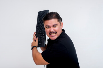 An irate man threatens to hit someone with a keyboard. A visual metaphor of a keyboard warrior....