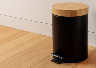 Stylish Black Pedal Trash Can with Bamboo Lid on Wooden Floor