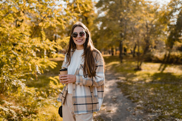 attractive young woman walking in autumn wearing jacket