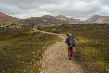 Fototapeta premium Solo hiker walking on a mountain trail in Iceland