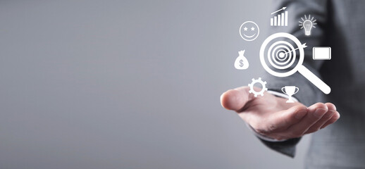 Human showing magnifying glass with a business icons. Searching success