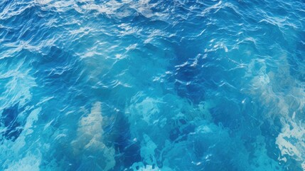 Fototapeta premium A stunning aerial view of the ocean, with the sun reflecting off the water. The waves create a beautiful pattern of light and dark blues.