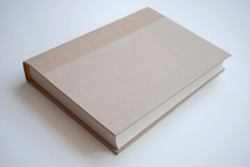 A blank book isolated on white. A beige blank book. A brown book mockup. 