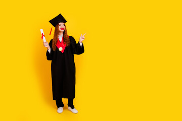 Photo of lovely diligent clever girl graduate study university look empty space isolated on yellow color background