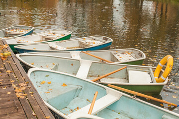 Old boat in the water and pier, autumn landscape