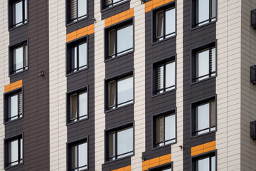 Modern ventilated facade with windows. Fragment of new elite residential building or commercial...