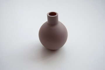 A jug isolated on white. A brown little vase close up. A beige empty vase close-up.