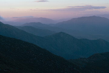The mountains are covered in a blue haze, creating a serene