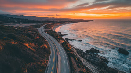 Fototapeta premium Sunset view on a coastal highway in California, USA, with the ocean on one side.