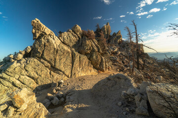 A rocky mountain with a path leading up to it