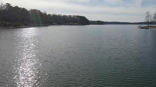 Flyover from a dock to the lake on a winter afternoon. Lake Murray in South Carolina.