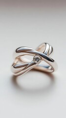 Naklejka premium Two intertwined rings, one with diamond, symbolizing eternal love.
