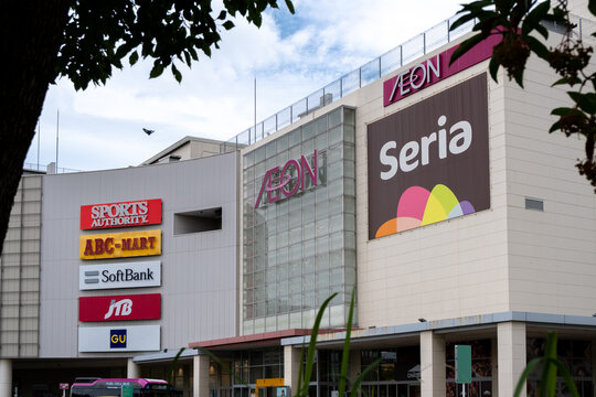 A large shopping mall in Nagoya, Aichi, Japan with various signs and logos, including AEON, Seria, Sports Authority, ABC-MART, SoftBank, and GU.