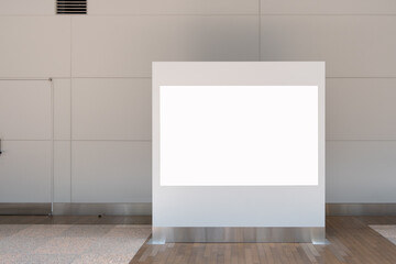 A sleek and professional background texture features a large, blank white billboard on a metal stand in a modern, minimalist indoor public hallway,copy space for advertising or displaying information.