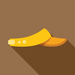 Yellow tennis cap casting a long shadow on brown background, side view