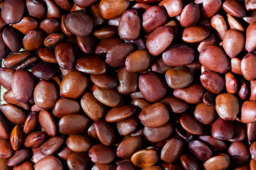 heap of carob seeds old measure faith diamonds as background