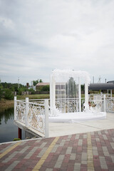 Street white flower arch on the lawn for the wedding ceremony.
