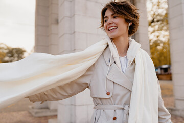 pretty smiling woman walking in park in winter clothes