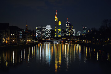 Fototapeta premium Frankfurt's Skyline Shimmers in the Night: A City Awash in Golden Light