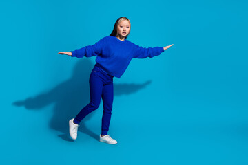 Full length body photo funny youth philippine girl with dyed hairstyle flying two arms wings isolated on blue color background