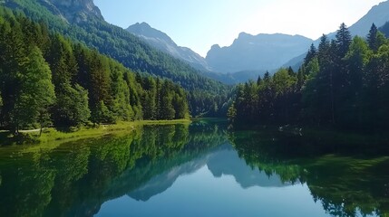 Fototapeta premium Serene lake surrounded by lush green trees and majestic mountains on a sunny day.