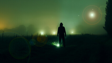 A mysterious glowing UFO in the sky. With a mysterious hooded figure. Standing in the countryside...