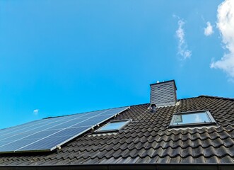 Solar panels producing clean energy on a roof of a residential house