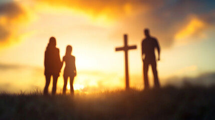 Fototapeta premium Blurry silhouette of a family standing in front of a cross 