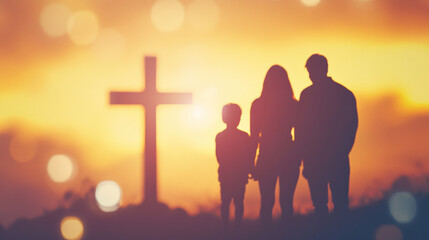 Blurry silhouette of a family standing in front of a cross  © EnricaDjango