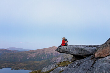 Children and adults, family with dog, hiking Grytetippen trail in Senja, Lofoten on a sunny summer day