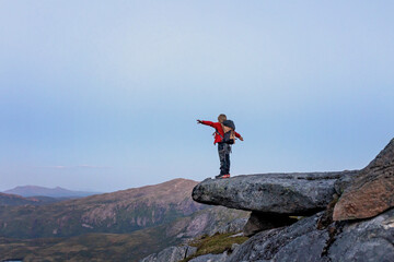 Obraz premium Children and adults, family with dog, hiking Grytetippen trail in Senja, Lofoten on a sunny summer day
