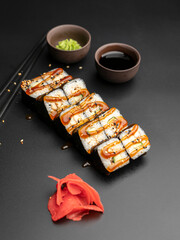Unagi maki with an eel on a black background