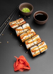 Unagi maki with an eel on a black background